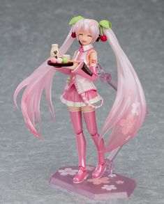 a figurine is holding a plate with a cake on it and wearing pink clothing