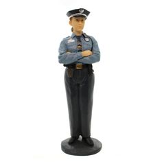 a figurine of a police officer is standing with his arms crossed on his chest