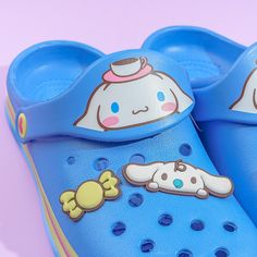 a pair of blue children's crocs with cartoon characters painted on them