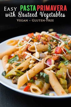 pasta primavera with sauteed vegetables on a white plate