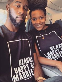 a man and woman wearing black happy & married t - shirts while sitting on an airplane