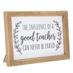 a wooden sign that says the influence of a good teacher can never be erased