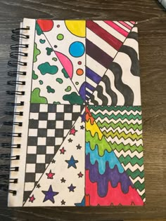 a spiral notebook with colorful designs on it