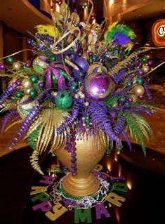 a vase filled with lots of purple and green decorations