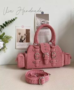 pink crocheted handbag with matching purse and leash, on white table next to flowers