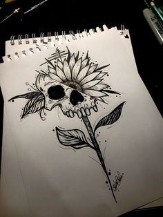 a drawing of a sunflower with a skull on it