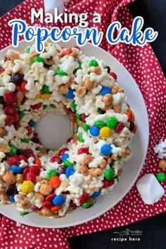 a white plate topped with popcorn cake covered in candy