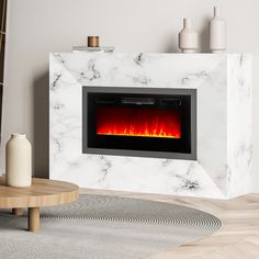 a white marble fireplace with an electric fire in the center and red flames on it