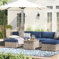 an outdoor living area with blue and white furniture