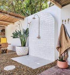 an outdoor shower in the middle of a patio