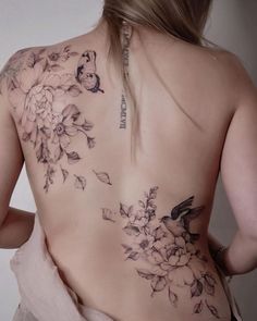 the back of a woman's body with flowers on it