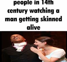 a man and woman laughing together in front of a sign that says, people in 14th century watching a man getting skinnyed alive