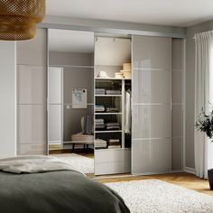 a bedroom scene with focus on the open closet doors and carpeted floor, along with a bed