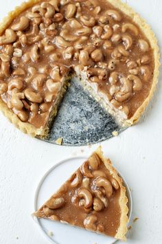 there is a pie with nuts on it and one slice has been cut from it