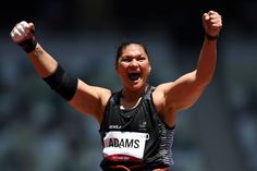 a female athlete raising her arms in the air