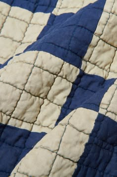 a blue and white quilt with an interesting design