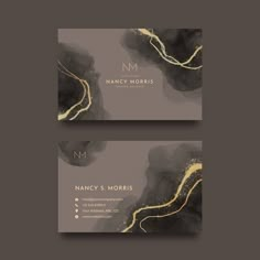 two business cards with black and gold paint