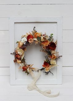 a wreath is hanging on the side of a white wall