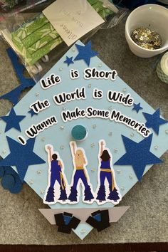 a blue graduation cap with the words life is short, the world is wide and i wanna make some memories