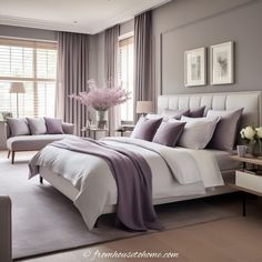 a large bed sitting in a bedroom next to two chairs and a table with flowers on it