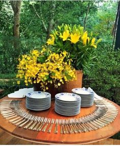 a table with plates and flowers on it