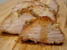 pork chops sitting on top of a wooden cutting board