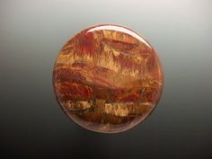 an orange and brown object sitting on top of a black table next to a white wall