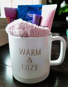 a coffee cup filled with pink stuff on top of a table