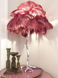 an ostrich feather lamp on a pink table