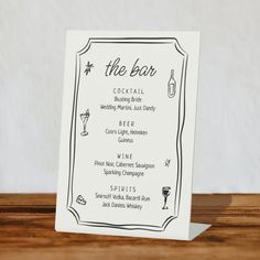 the bar menu card is displayed on a wooden table