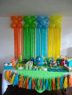 a table with balloons, streamers and decorations on it for a sesame the movie birthday party