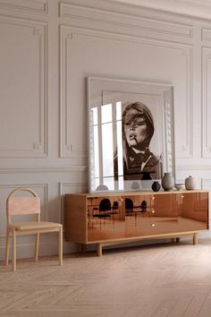 an instagram photo of a living room with white walls and wooden furniture in it