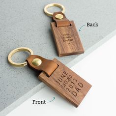 two personalized wooden keychains with names on them