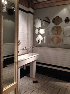 a bathroom with two sinks and mirrors on the wall