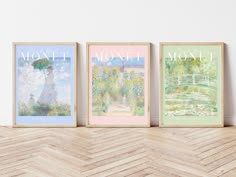 three framed art prints on a wall above a wooden table with a chevron wood floor