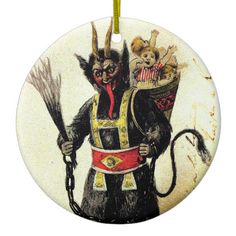 a round ceramic ornament with an image of a cat holding two brooms