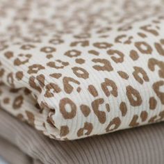 the fabric is brown and white with leopard print on it's sides, as well as an animal - print pattern