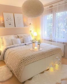 a bedroom with a large bed and white fur rugs on the floor in front of two windows