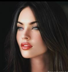 a woman with long dark hair and blue eyes is looking into the distance while wearing red lipstick