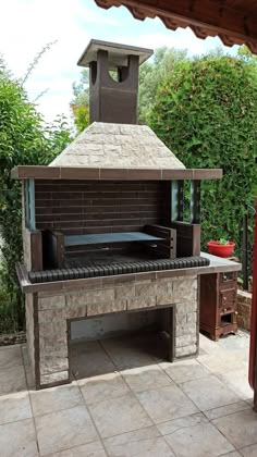 an outdoor grill with a brick oven on it