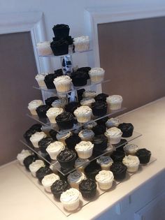 a tower of cupcakes is displayed on a table