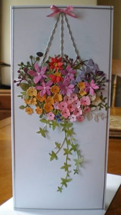 a card with flowers hanging from it's side