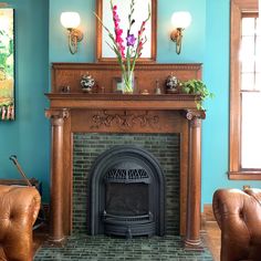 a living room filled with furniture and a fire place in front of a painting on the wall