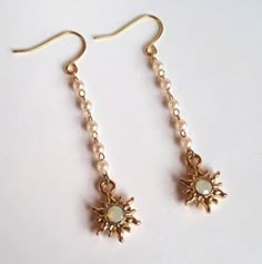 Offers Welcome Hypo-Allergenic Perfect For Sensitive Ears These Sunburst Earrings Are Made Of Little Gold Sunbust Charms That Are Paved With Opalescent Crystals In The Centers. Above The Gold Sunburts Is A Tiny White Pearl Chain That The Sunbursts Hang From. Earrings Hang On Gold French Ear Wires. Chains Earrings, Pearl Chains, Gold Sunburst, Opalite Crystal, Crystal Pearl Earrings, Chain Drop Earrings, Earrings Inspiration, Jewellery Ideas, Heart Drop Earrings