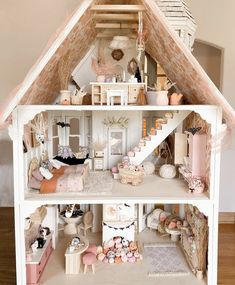 a doll house with furniture and accessories inside