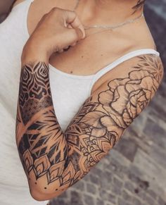 a woman with tattoos on her arm and shoulder