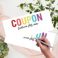 a person holding a piece of paper with the word coupon written on it and writing underneath