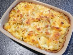 a casserole dish with cheese on it sitting on a counter top, ready to be eaten