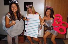 three women dressed up in costumes posing for the camera with paper cutouts and scissors