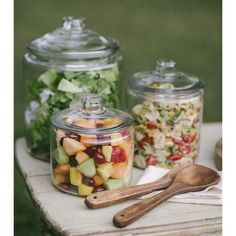 several glass containers filled with different types of food